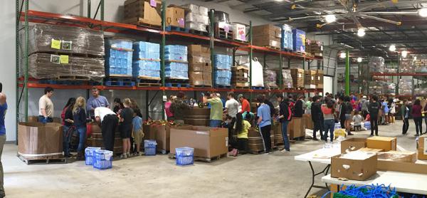 Volunteers sort food at a food bank.